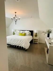 Cozy bedroom with neatly made bed and soft lighting